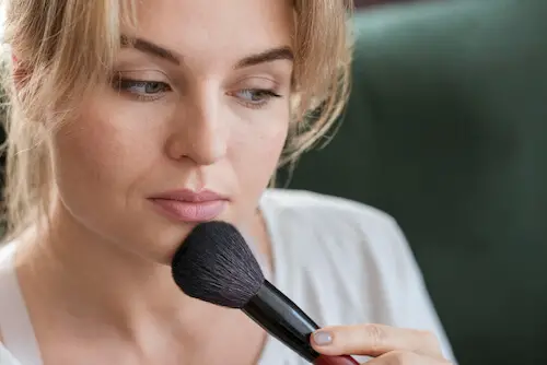 woman using brush her make up 1